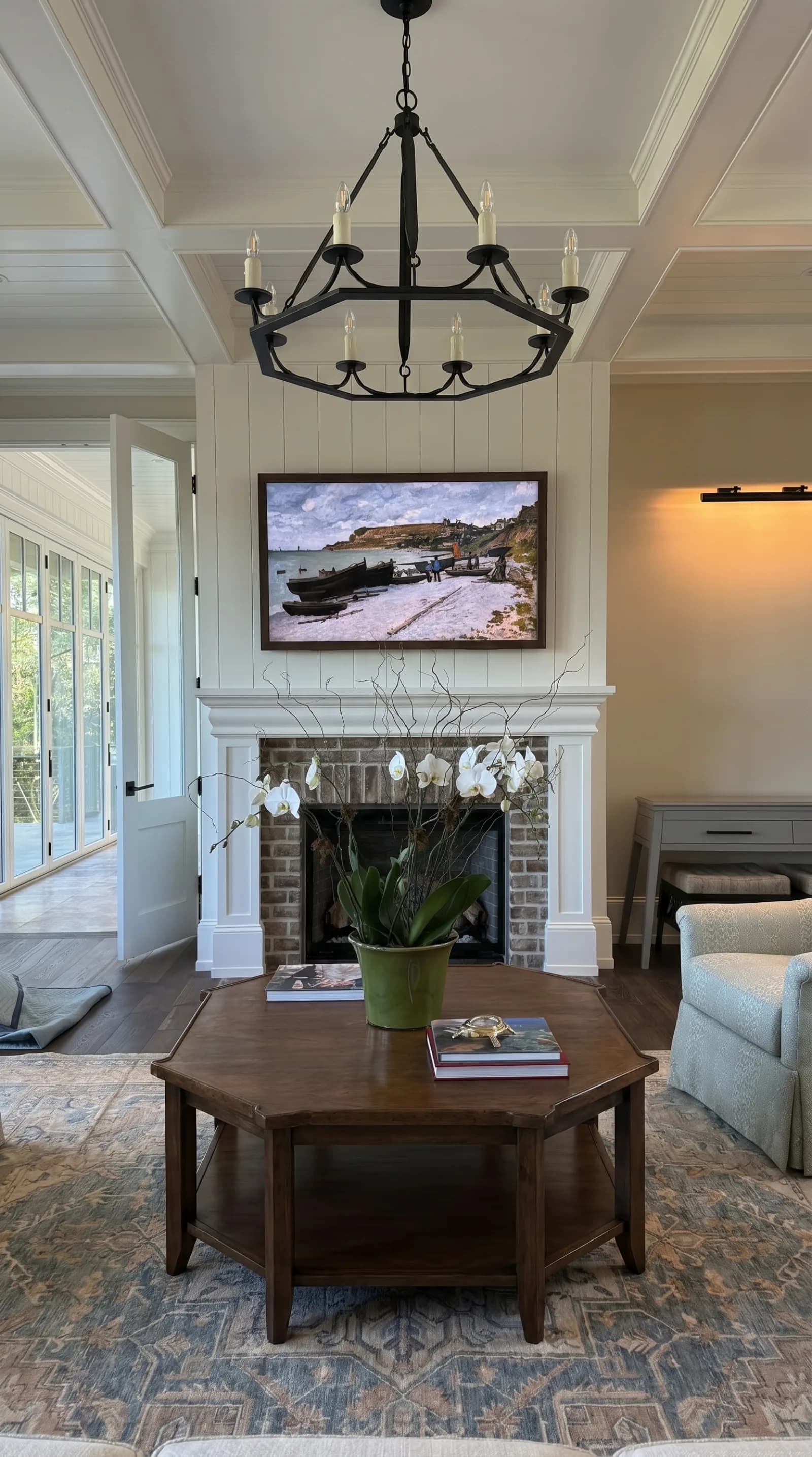 Frame TV above a brick fireplace in a cottage living room