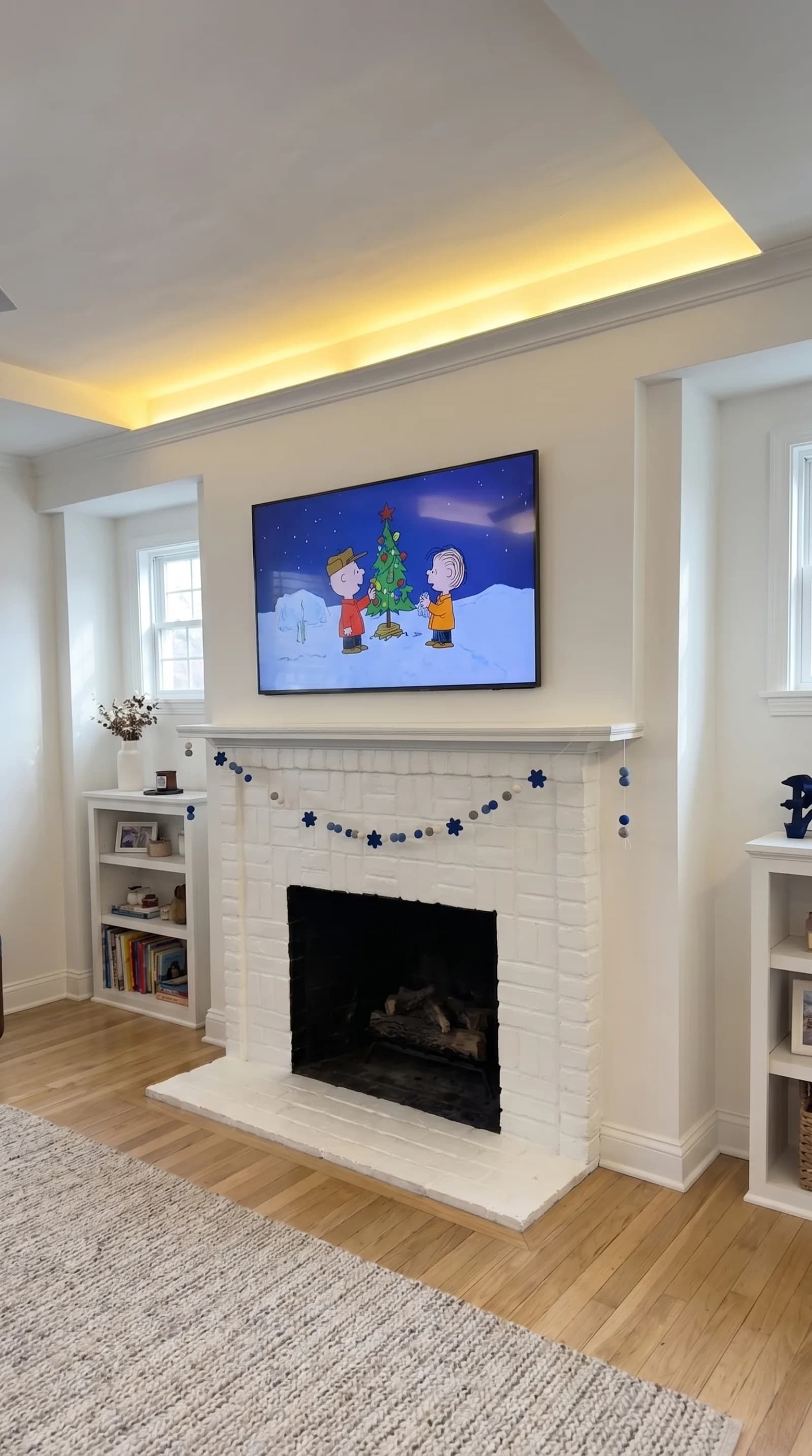 TV above a white-brick fireplace with LED accent lighting