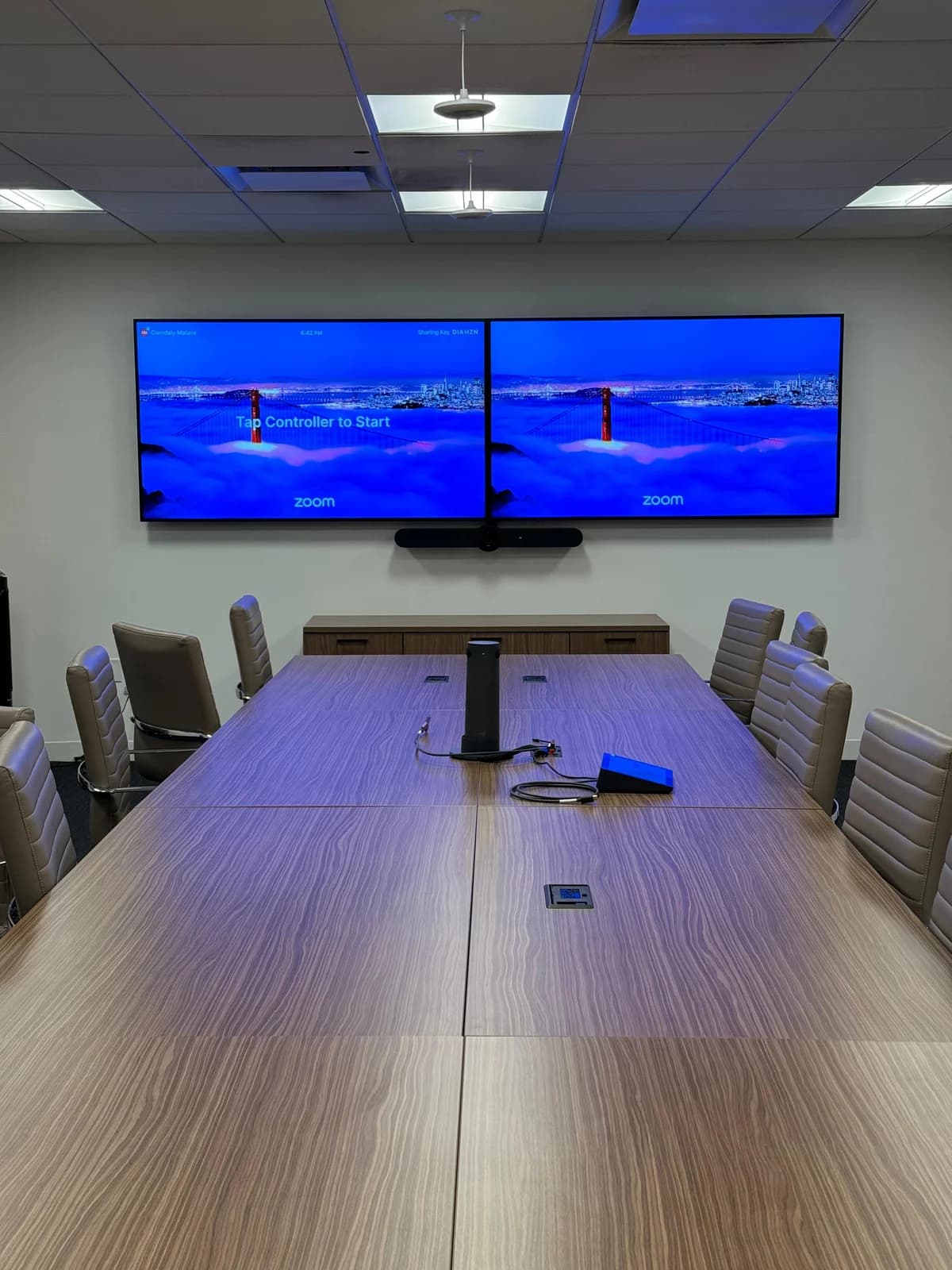 Corporate boardroom with dual Zoom displays