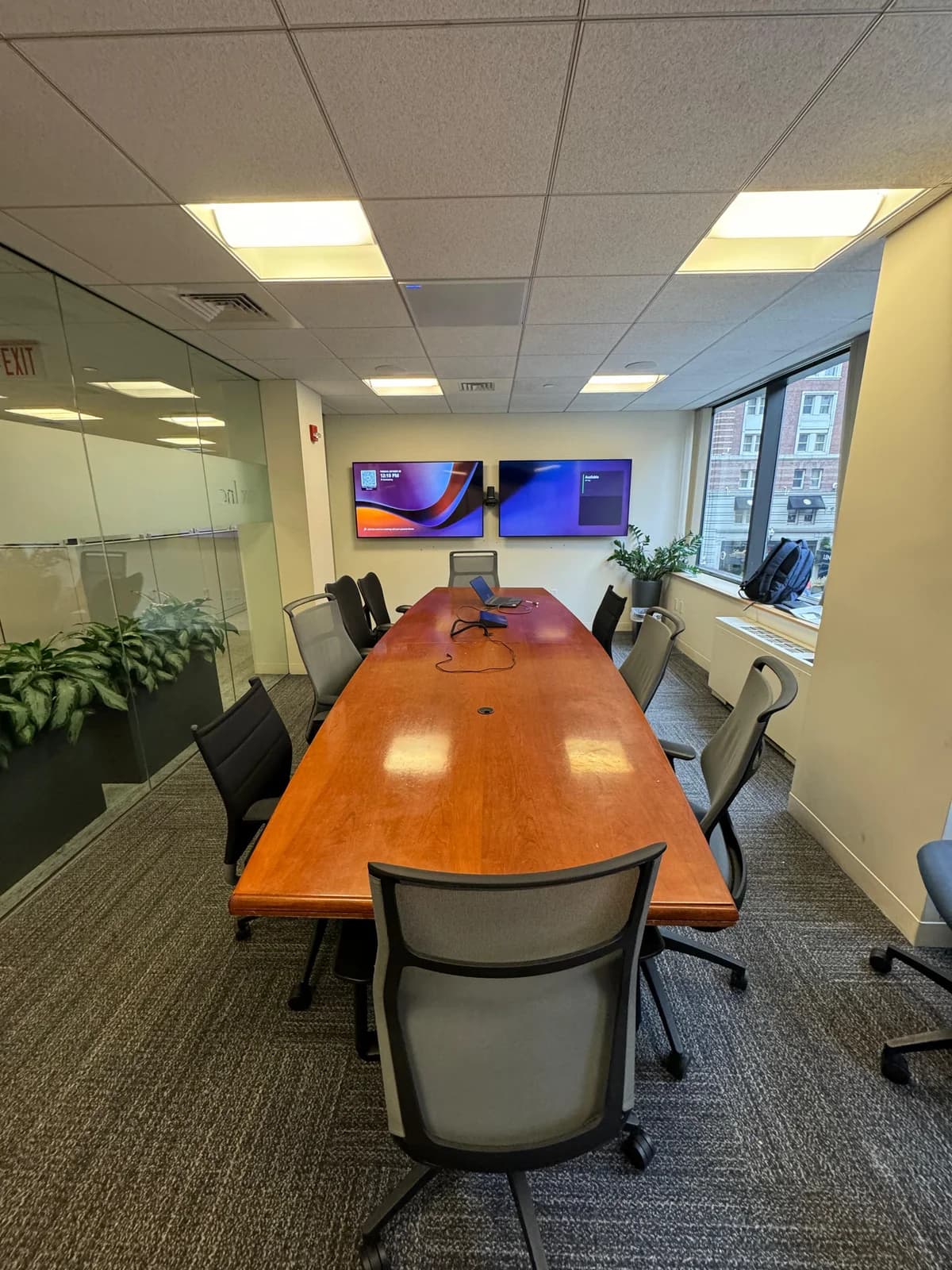 NYC office conference room with dual wall-mounted displays and video conferencing