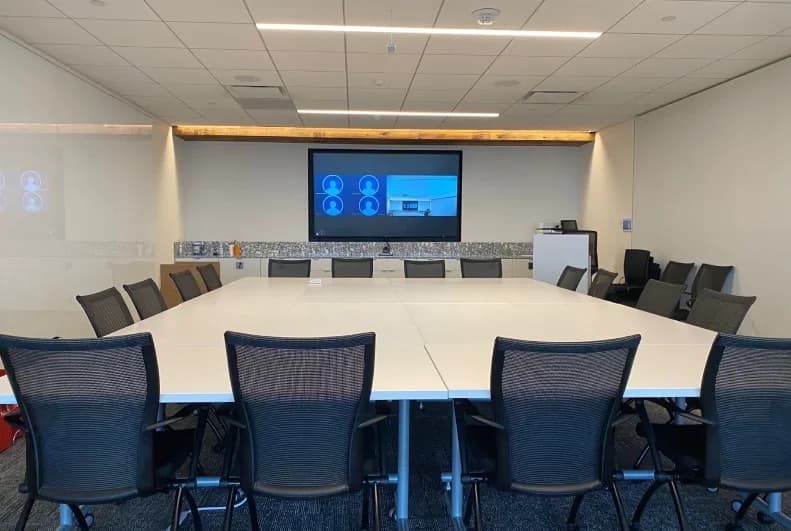 Large boardroom with AV displays and a conferencing setup