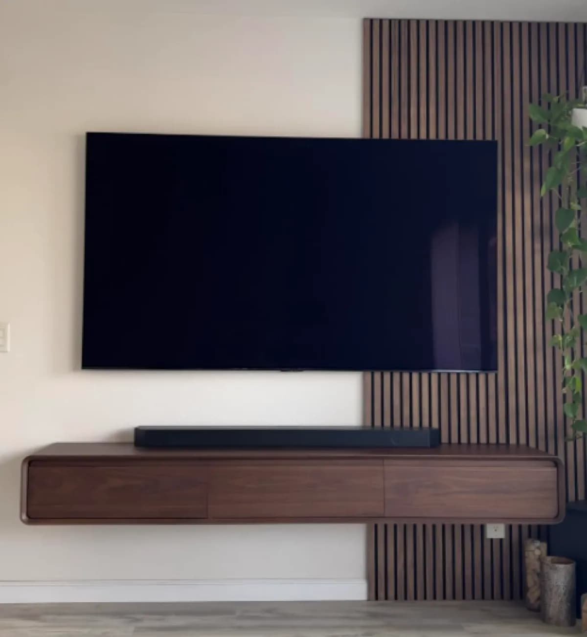 TV mounted on a floating stand with LED underlight in a NYC living room