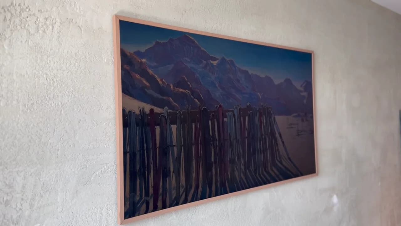 Frame TV with mountain ski-lodge artwork,