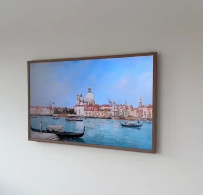 Samsung Frame TV mounted flush with wood bezel, power and cable hidden inside the wall, no visible wires