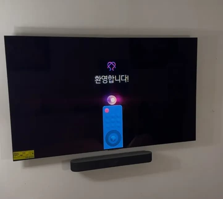 Wall-mounted TV with soundbar below and all power and HDMI cables hidden inside the wall