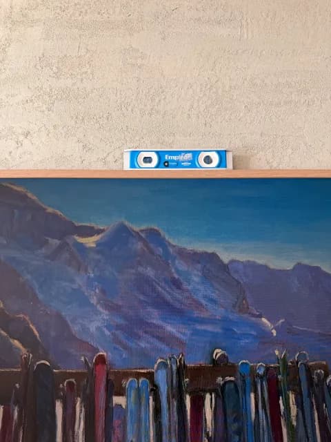 Frame TV with mountain ski-lodge artwork,