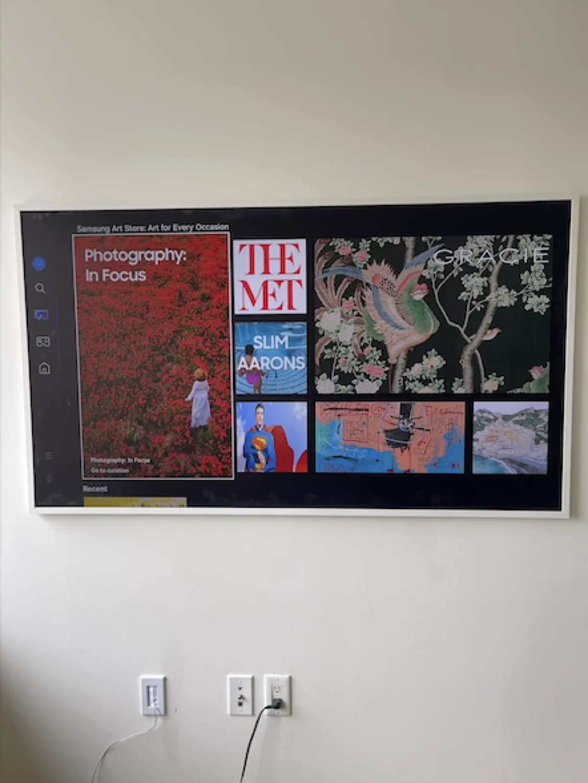 Samsung Frame TV mounted flush on an NYC apartment wall displaying Art Store with One Connect cable routed inside the drywall