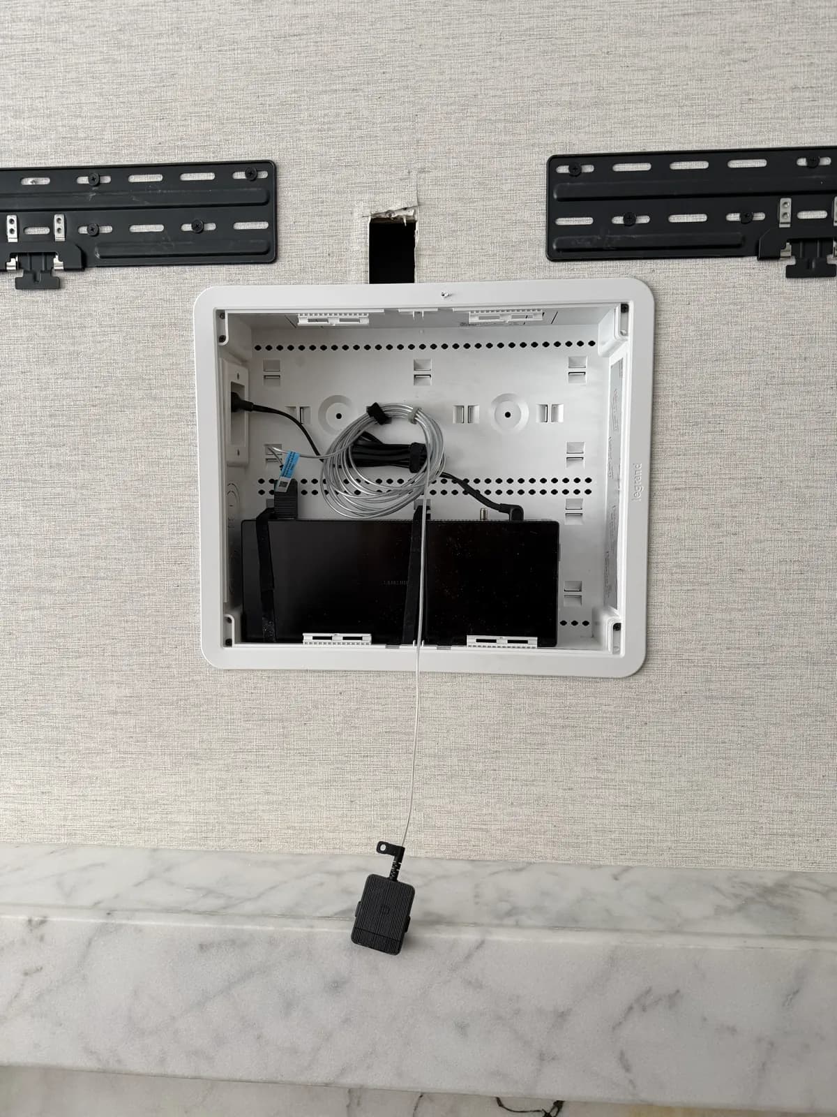 Samsung Frame TV in-wall recessed box installed flush in drywall with bracket rails on either side