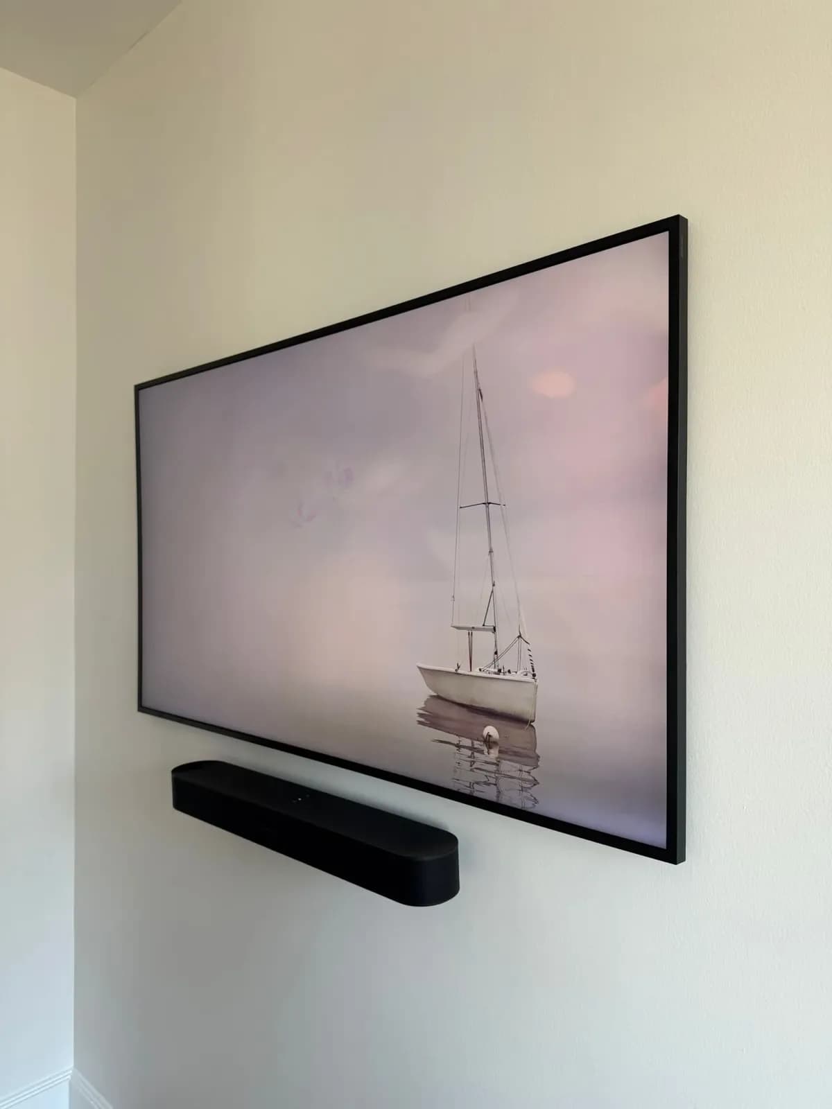 Framed TV wall-mounted in an NYC apartment with a floating Sonos soundbar beneath it
