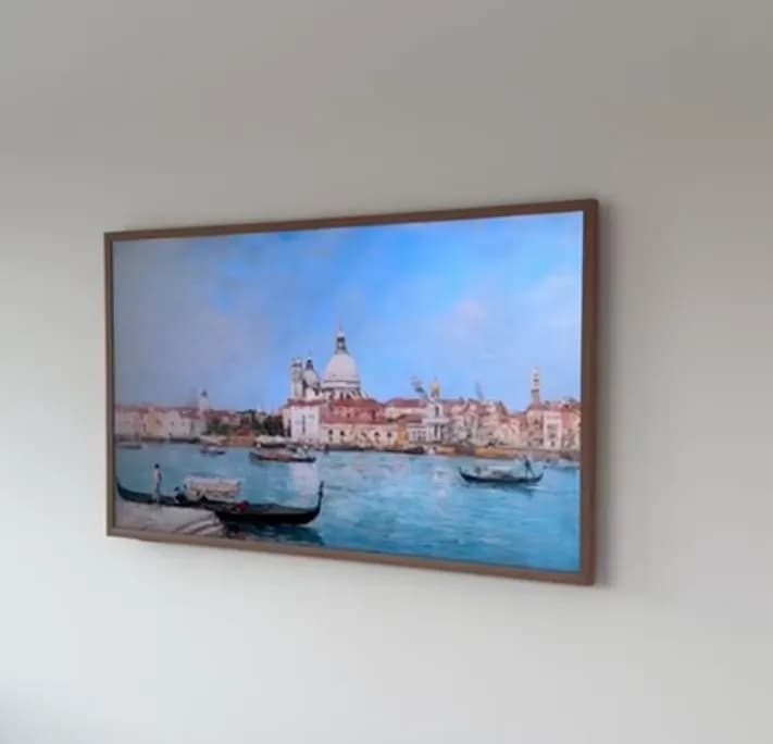 Samsung Frame TV mounted flush with wood bezel, power and cable hidden inside the wall, no visible wires