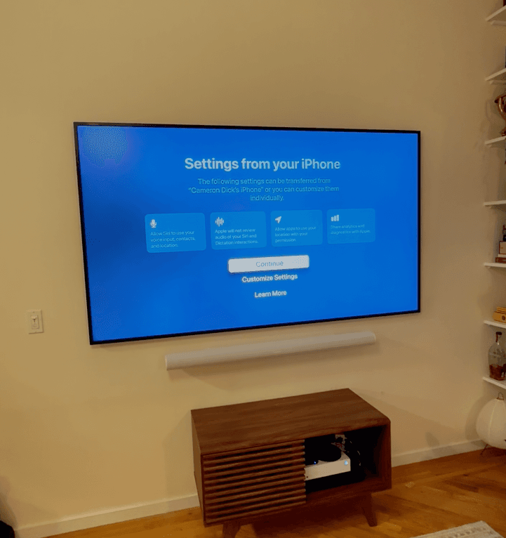 Samsung Frame TV mounted flush on a living room wall with the One Connect cable hidden in the wall