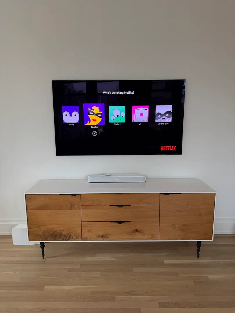 The finished wall with the TV above the credenza and the soundbar.