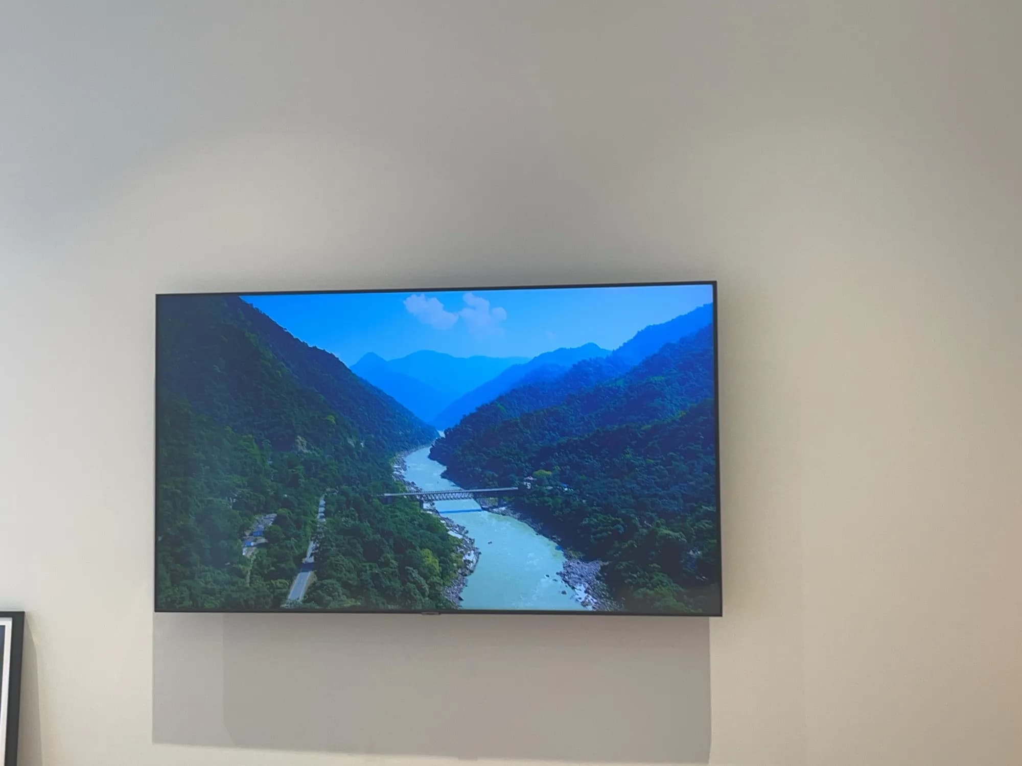 The wall-mounted living room TV from a slightly different front angle.