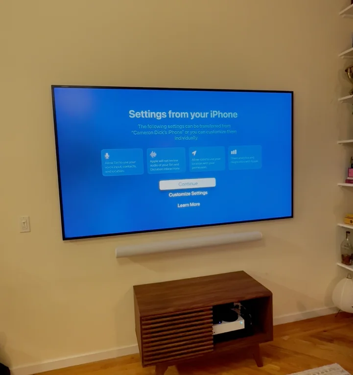 Modern living room with a wall-mounted TV and soundbar setup in a NYC apartment