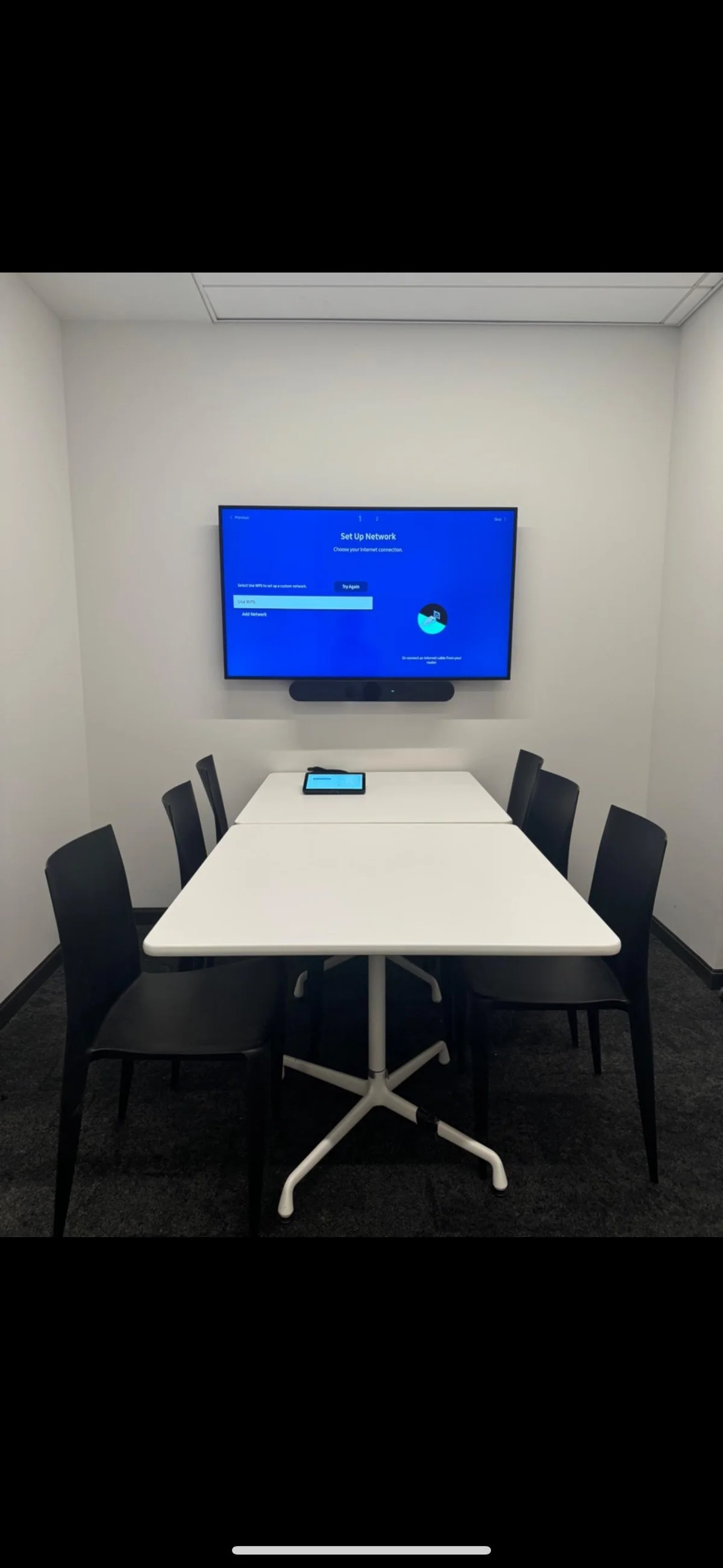 Small huddle room with mounted display and soundbar