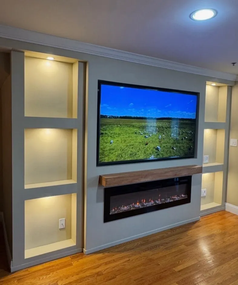 Custom media wall with LED shelves and fireplace